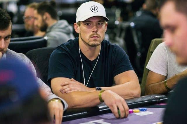 Alex Foxen playing poker wearing a white cap