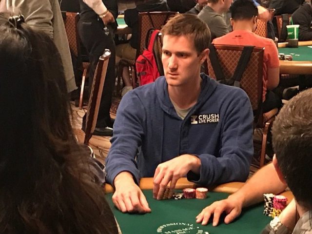 Brad Owens playing poker wearing a blue hoodie